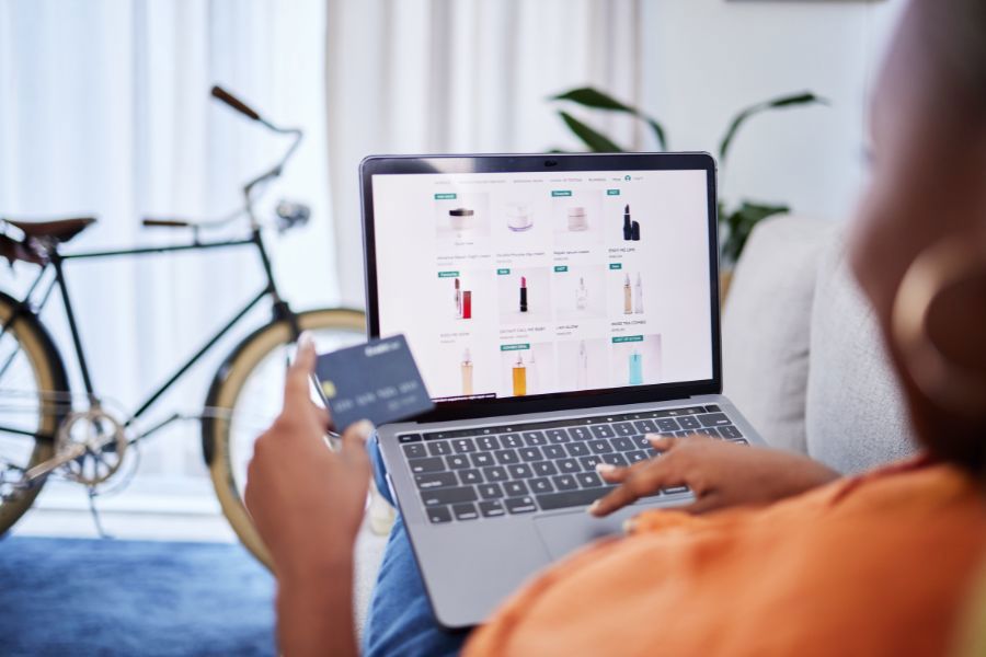 A consumer shops online for products from their living room.