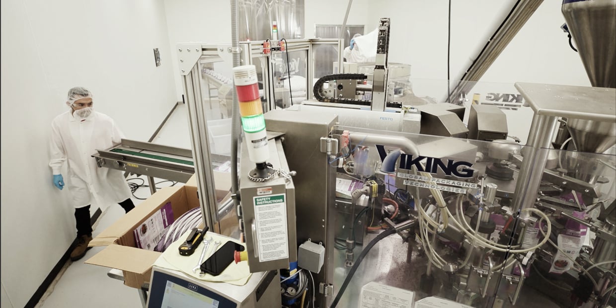 Ryder employee operating automated equipment in a contract manufacturing facility Ryder employee operating automated equipment in a contract manufacturing facility
