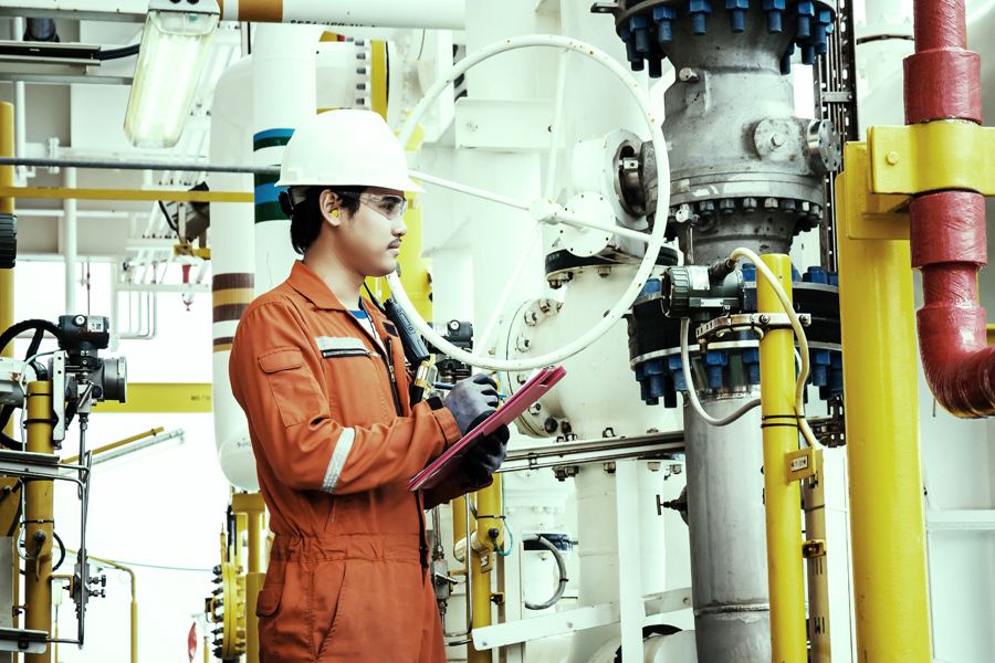 A ryder employee performing safety checks at an oil and gas facility