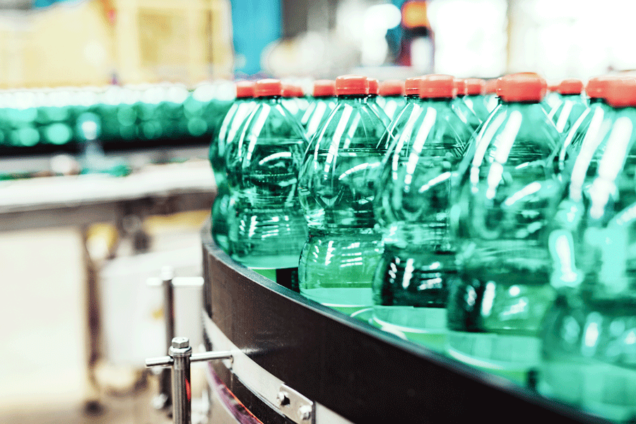 food & beverage warehousing assembly line with green bottles on conveyor line