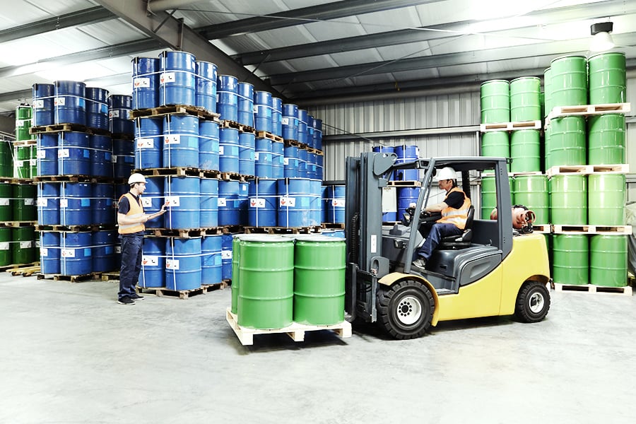 Forklift transporting chemicals in a warehouse