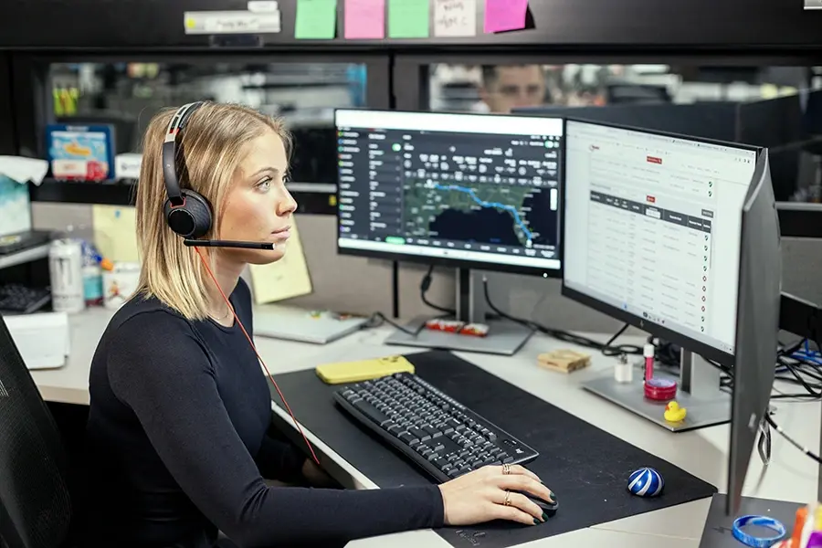 Ryder transportation control tower specialist monitoring inbound freight on multiple screens Ryder transportation control tower specialist monitoring inbound freight on multiple screens