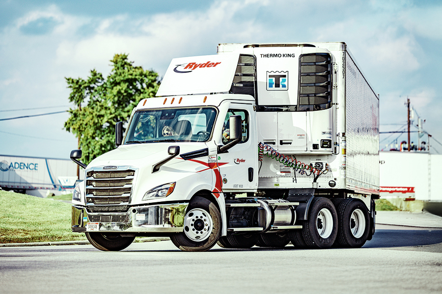 White Ryder day cab tractor with a refrigerated trailer parked in a lot