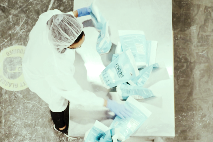 contract manufacturing services worker sorting flexible packages