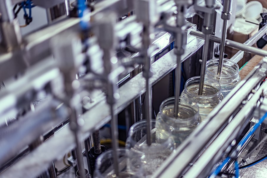 A beverage being manufactured and packaged on an assembly line