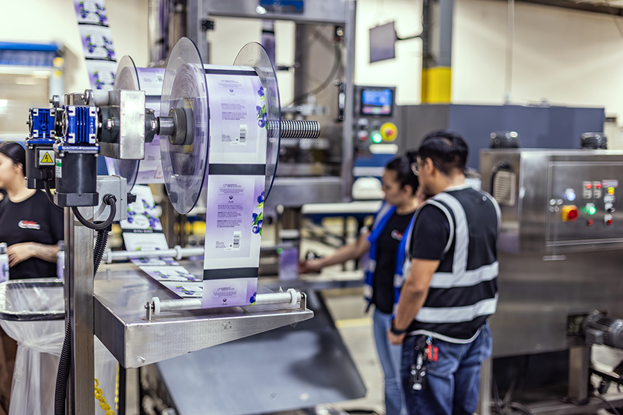 A machine spooling out rollstock packaging