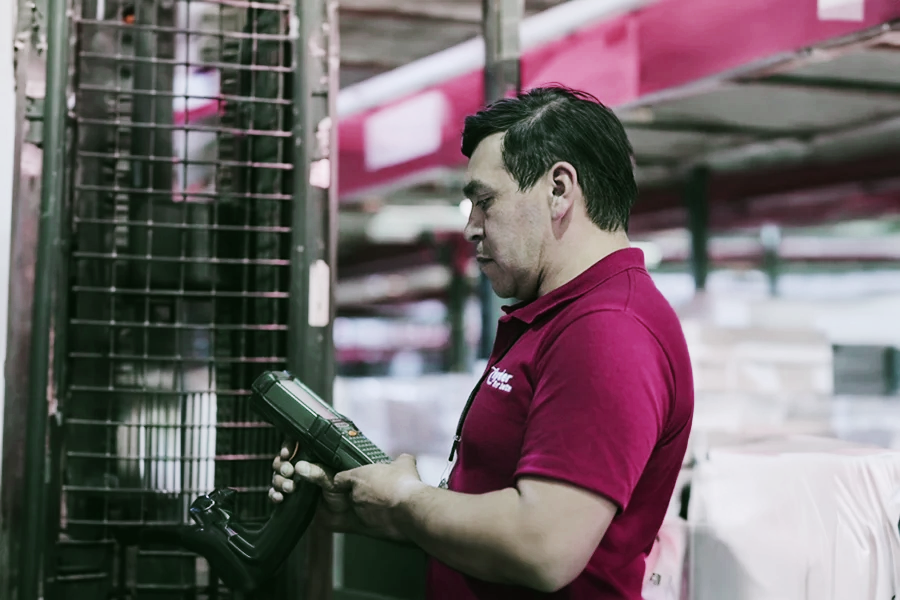 employee with hand held device at a warehouse