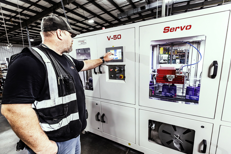 Ryder nearshoring manufacturing worker operating industrial equipment in a production facility