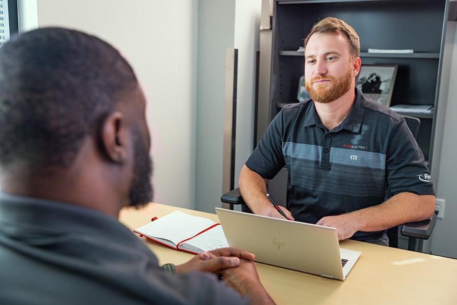 two men sitting oposite at a desk in a nearshoring consultation