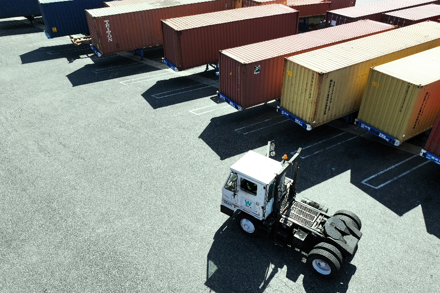 Truck driving through a cross border logistics shipping yard