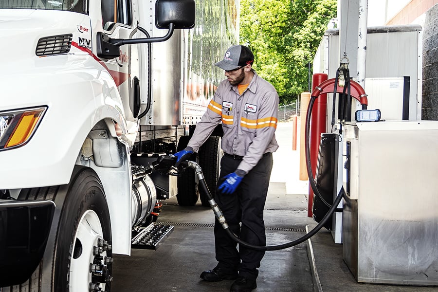A Ryder technician filling up a semi truck