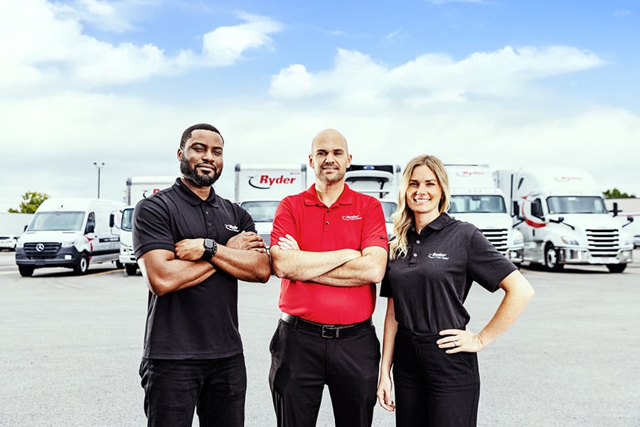 A Ryder rental dedicated account team in front of their trucks