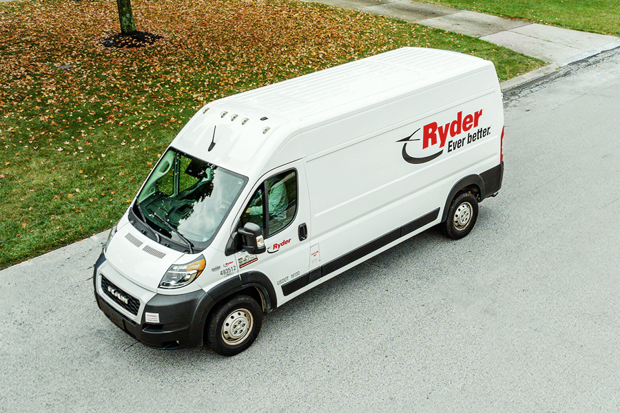 White Ryder cargo van available for commercial truck rental parked on the street