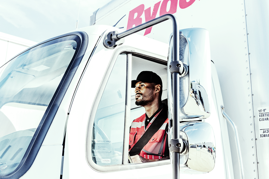 Ryder white glover delivery driver in a Ryder box truck