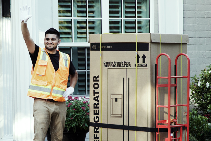 Ryder last mile employee deliverying a refrigerator