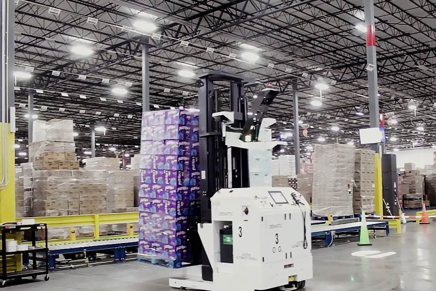 Automated guided vehicle (AGV) moving pallets along a fixed warehouse route Automated guided vehicle (AGV) moving pallets along a fixed warehouse route