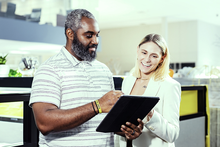A Ryder employee helping a customer integrate Rydershare with their business technology