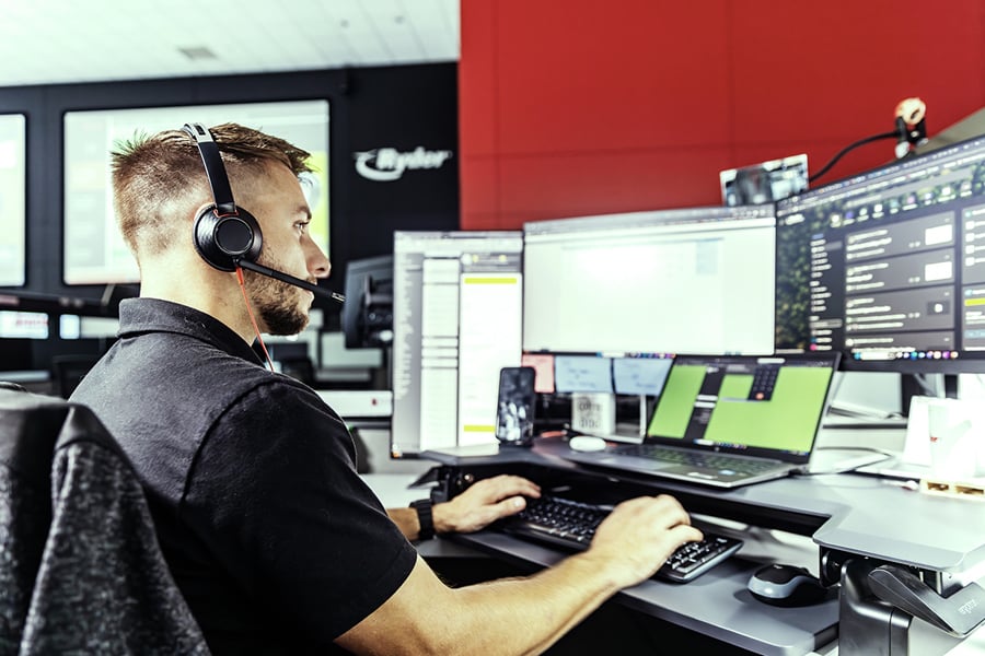 A Ryder transportation management employee working on a monitor