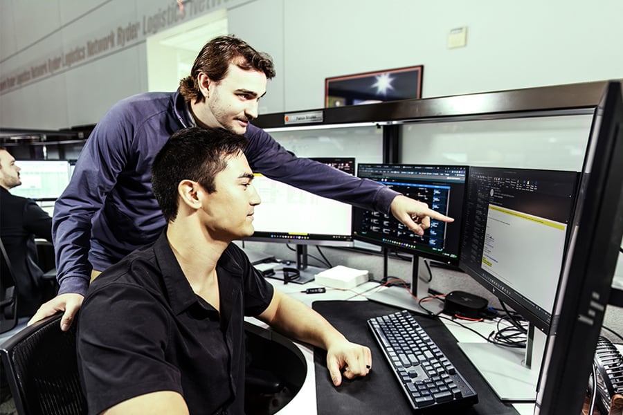 two Ryder transportation management employees working together