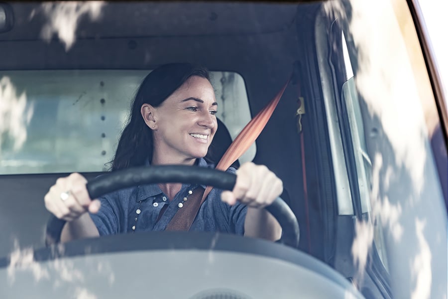 A Ryder customer driving off the lot in her newly purchased box truck A Ryder customer driving off the lot in her newly purchased box truck