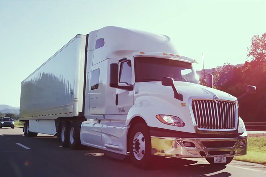 Video showcasing Ryder tandem axle sleeper tractor-trailer delivering goods